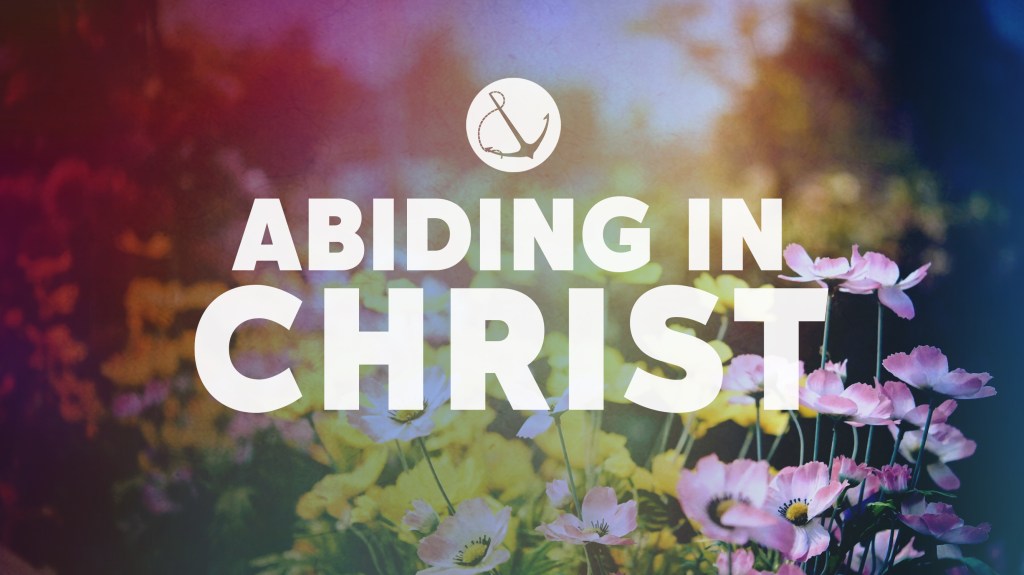 Image of a colorful field of flowers with text overlaid, "Abiding in Christ"